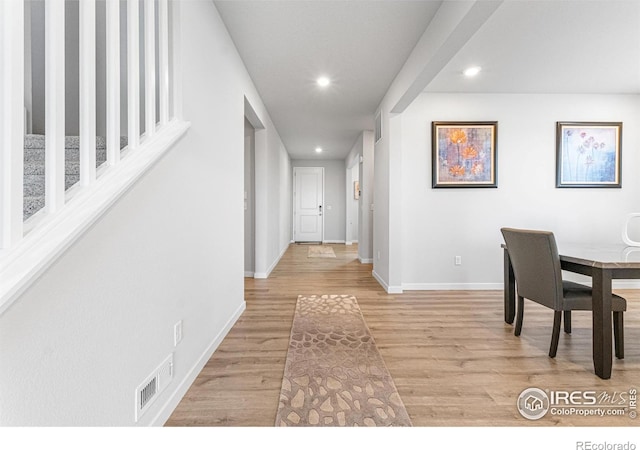 5766 Ranch St, Longmont, CO 80504 - hallway featuring light wood-style floors, recessed lighting, and stairway