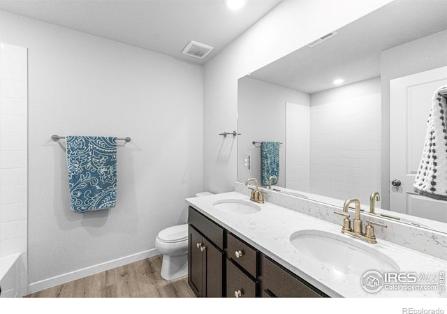 5766 Ranch St, Longmont, CO 80504 - bathroom featuring wood finished floors, double vanity, and recessed lighting