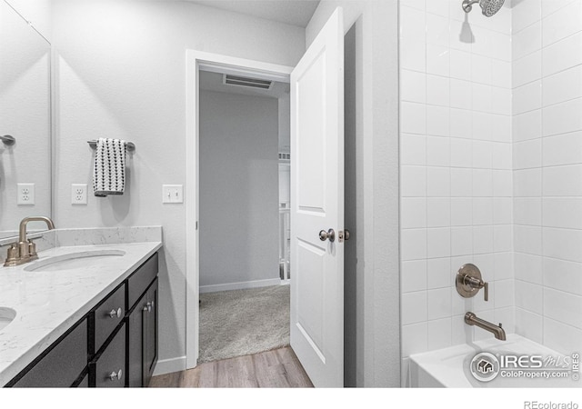 5766 Ranch St, Longmont, CO 80504 - full bath with wood finished floors, double vanity, and tub / shower combination