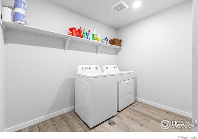 5766 Ranch St, Longmont, CO 80504 - laundry room with independent washer and dryer and light wood finished floors