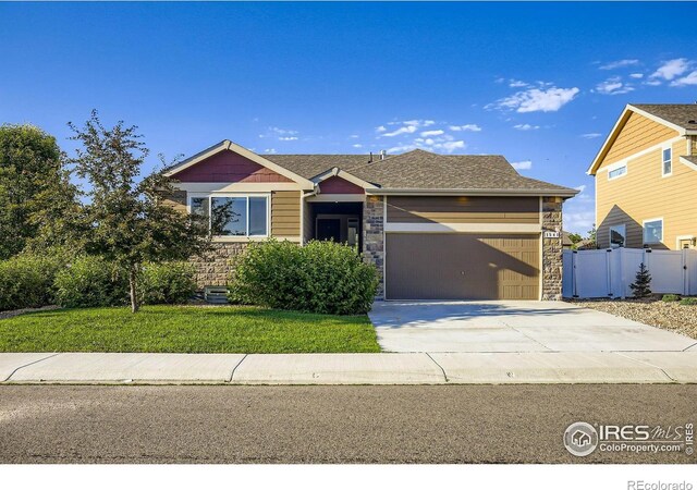 1541 Water Vista Ln, Severance, CO 80550 - ranch-style house featuring stone siding, a garage, and driveway