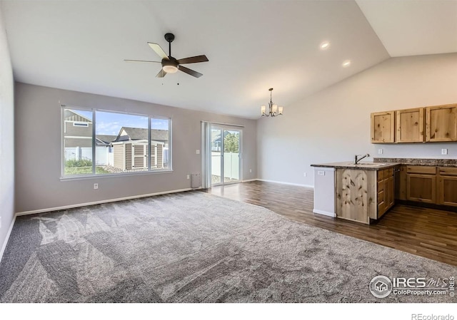 1541 Water Vista Ln, Severance, CO 80550 - kitchen featuring dark colored carpet, vaulted ceiling, open floor plan, a chandelier, and recessed lighting