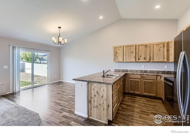 1541 Water Vista Ln, Severance, CO 80550 - kitchen featuring appliances with stainless steel finishes, a peninsula, dark wood finished floors, a chandelier, and lofted ceiling