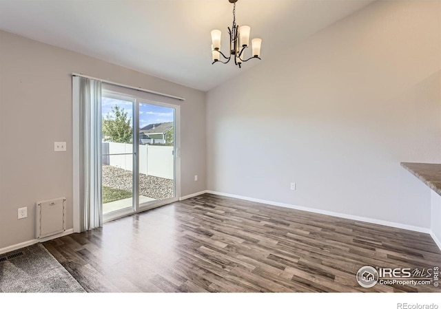 1541 Water Vista Ln, Severance, CO 80550 - unfurnished dining area featuring wood finished floors, a chandelier, and lofted ceiling