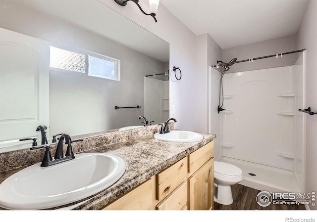 1541 Water Vista Ln, Severance, CO 80550 - bathroom with a shower, wood finished floors, and double vanity