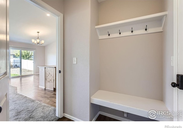 1541 Water Vista Ln, Severance, CO 80550 - mudroom featuring a chandelier and wood finished floors