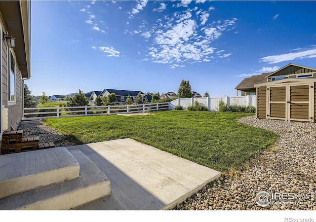1541 Water Vista Ln, Severance, CO 80550 - fenced backyard featuring a storage shed and a patio area