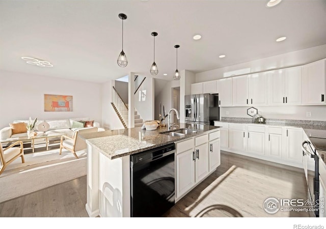 5217 Alberta Falls St, Timnath, CO 80547 - kitchen with dishwasher, stainless steel fridge with ice dispenser, open floor plan, light stone countertops, and recessed lighting