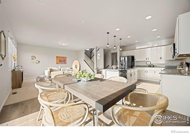 5217 Alberta Falls St, Timnath, CO 80547 - dining room with light wood-style flooring, stairs, and recessed lighting