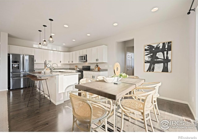 5217 Alberta Falls St, Timnath, CO 80547 - dining space with dark wood finished floors and recessed lighting