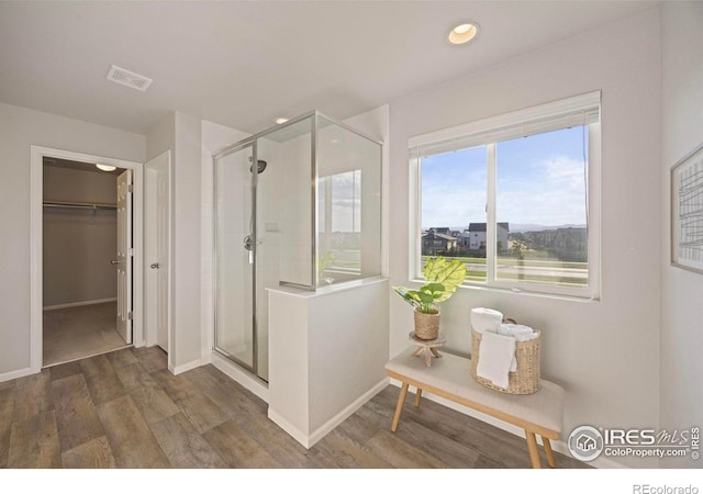 5217 Alberta Falls St, Timnath, CO 80547 - full bathroom with a shower stall, wood finished floors, a walk in closet, and recessed lighting