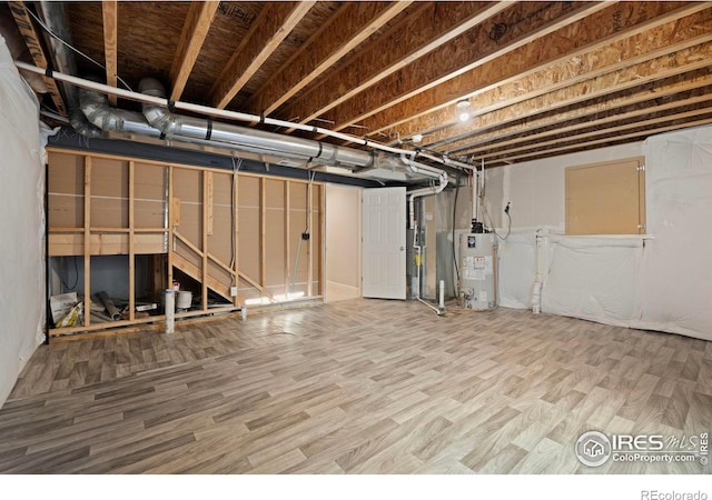 5217 Alberta Falls St, Timnath, CO 80547 - unfinished basement featuring gas water heater and wood finished floors