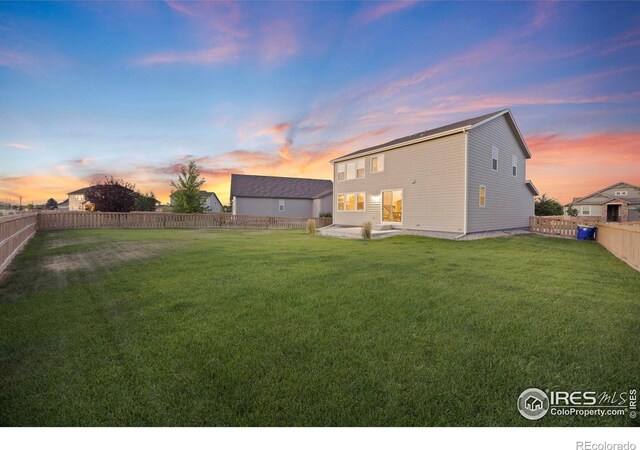 5217 Alberta Falls St, Timnath, CO 80547 - back of property at dusk with a fenced backyard