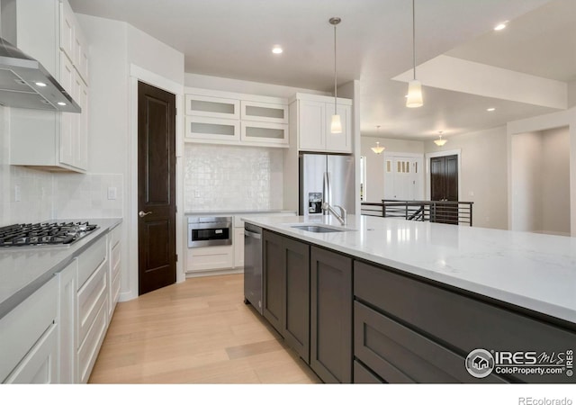 24113 E 36th Pl, Aurora, CO 80019 - kitchen with wall chimney range hood, stainless steel appliances, white cabinets, tasteful backsplash, and recessed lighting