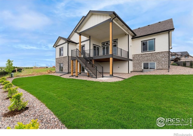 24113 E 36th Pl, Aurora, CO 80019 - back of property featuring stairs, a lawn, and a wooden deck