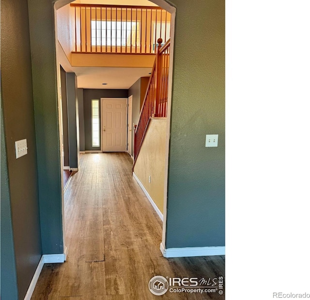 2395 Sandpiper Dr, Lafayette, CO 80026 - corridor with wood finished floors and stairs
