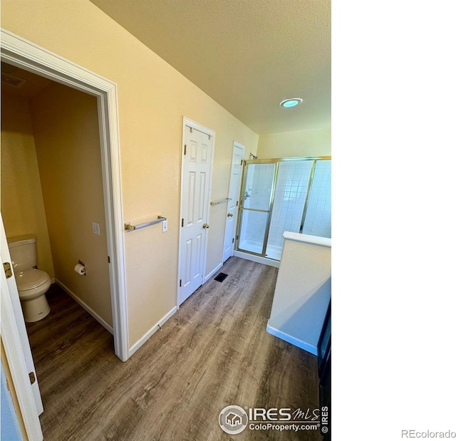 2395 Sandpiper Dr, Lafayette, CO 80026 - full bathroom with wood finished floors, a shower with door, and recessed lighting