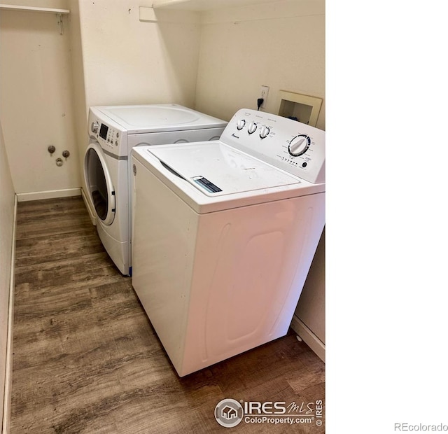 2395 Sandpiper Dr, Lafayette, CO 80026 - washroom featuring washing machine and dryer and wood finished floors