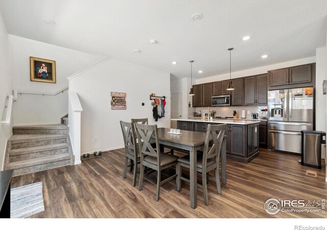 14203 Hop Clover Trl, Parker, CO 80134 - dining area featuring dark wood finished floors, stairway, and recessed lighting