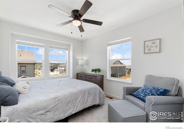 14203 Hop Clover Trl, Parker, CO 80134 - bedroom featuring multiple windows, carpet flooring, and a ceiling fan