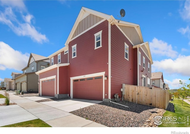 14203 Hop Clover Trl, Parker, CO 80134 - view of side of home featuring board and batten siding, a garage, concrete driveway, and a residential view