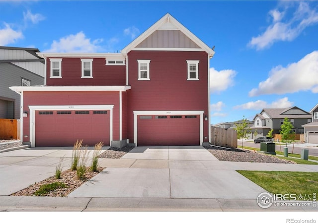 14203 Hop Clover Trl, Parker, CO 80134 - view of front facade featuring a garage, concrete driveway, board and batten siding, and a residential view