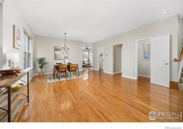 3882 W 118th Pl, Westminster, CO 80031 - dining area featuring a chandelier, light wood-style floors, and stairway