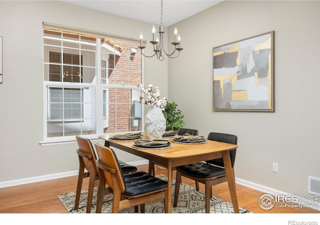 3882 W 118th Pl, Westminster, CO 80031 - dining area with a chandelier and wood finished floors