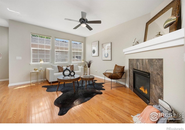 3882 W 118th Pl, Westminster, CO 80031 - living area with a tile fireplace, wood finished floors, and ceiling fan
