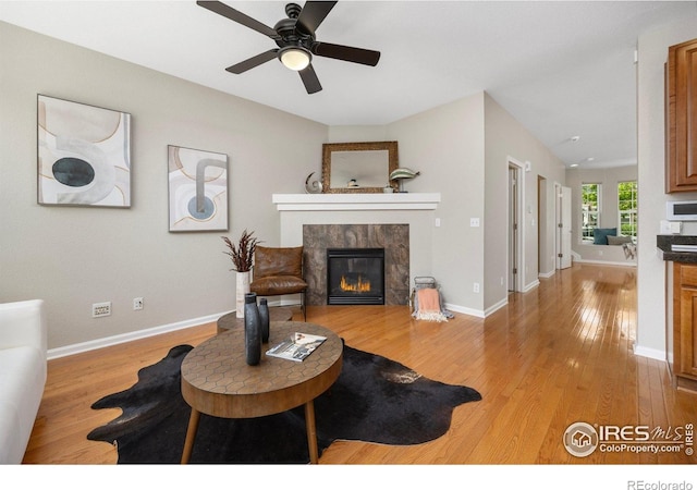 3882 W 118th Pl, Westminster, CO 80031 - living area with a fireplace, light wood-style floors, and ceiling fan