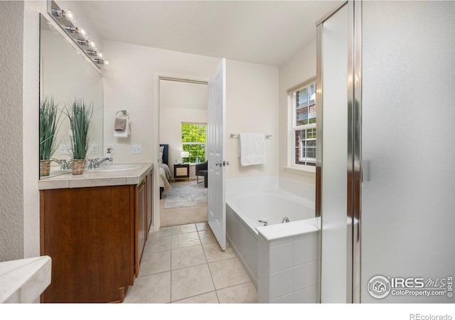 3882 W 118th Pl, Westminster, CO 80031 - ensuite bathroom featuring double vanity, a garden tub, and tile patterned floors