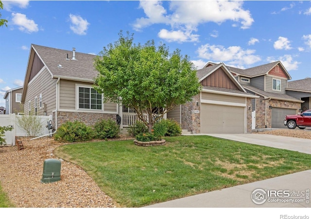 2302 74th Ave, Greeley, CO 80634 - view of front of property with board and batten siding, stone siding, driveway, and a shingled roof