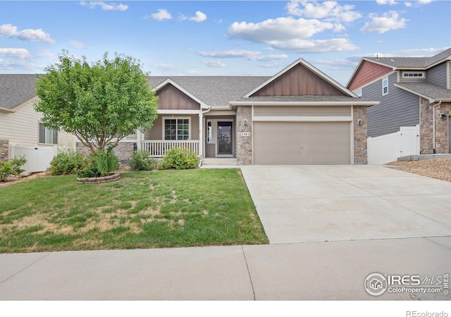 2302 74th Ave, Greeley, CO 80634 - craftsman inspired home featuring board and batten siding, an attached garage, covered porch, stone siding, and concrete driveway