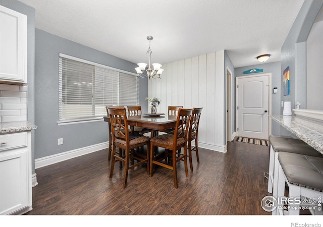 2302 74th Ave, Greeley, CO 80634 - dining space with a chandelier and dark wood finished floors