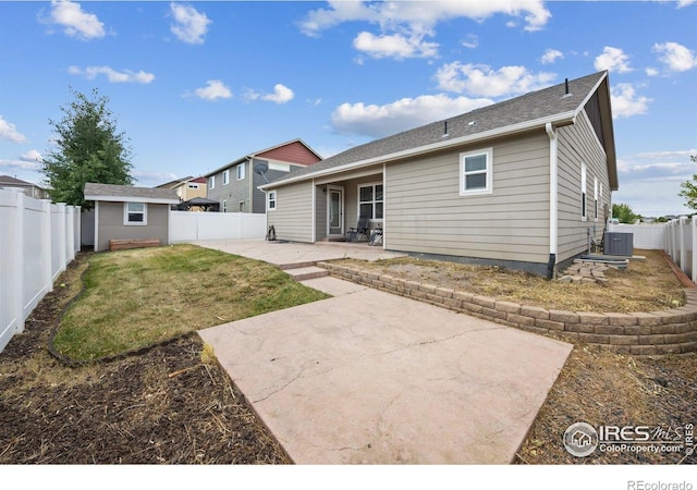 2302 74th Ave, Greeley, CO 80634 - back of property featuring a patio, a fenced backyard, and a storage unit