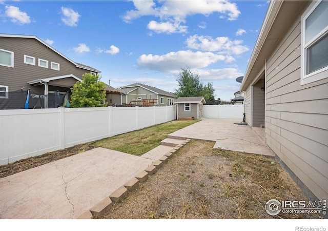 2302 74th Ave, Greeley, CO 80634 - fenced backyard featuring a patio area, a shed, and a residential view