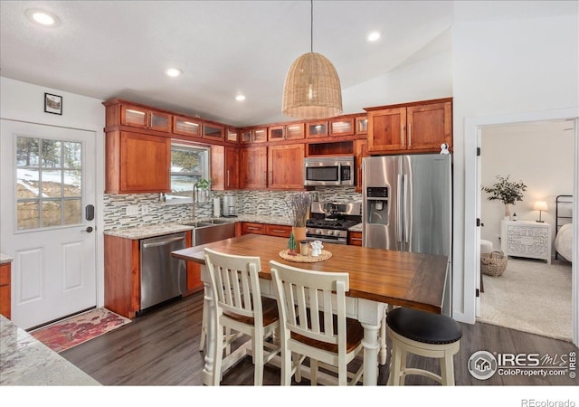 3367 Badger Creek Rd, Hartsel, CO 80449 - kitchen featuring appliances with stainless steel finishes, dark wood-type flooring, tasteful backsplash, glass insert cabinets, and vaulted ceiling