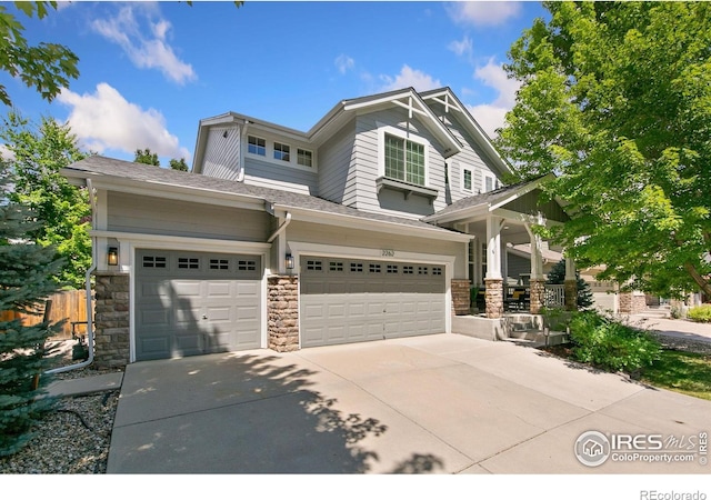 2262 Harvest St, Fort Collins, CO 80528 - craftsman-style house with stone siding, concrete driveway, an attached garage, and a porch