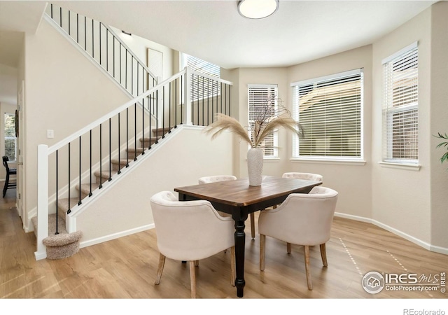 2262 Harvest St, Fort Collins, CO 80528 - dining room featuring wood finished floors, stairs, and plenty of natural light