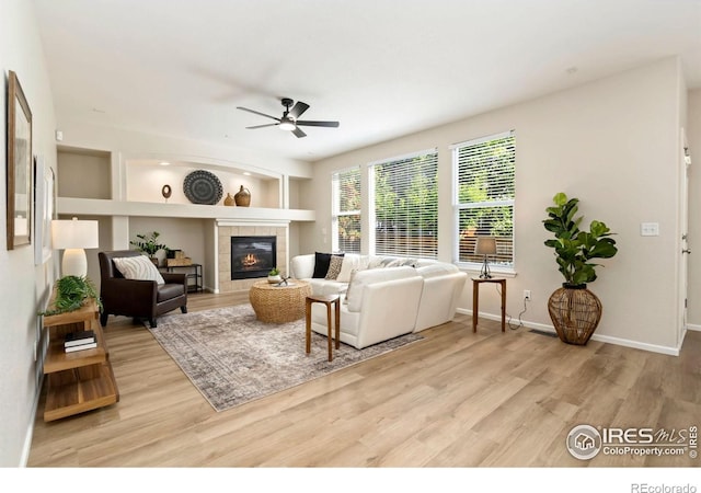 2262 Harvest St, Fort Collins, CO 80528 - living room featuring a ceiling fan, wood finished floors, and a tiled fireplace