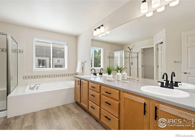 2262 Harvest St, Fort Collins, CO 80528 - full bath with a stall shower, double vanity, wood finished floors, a garden tub, and a spacious closet