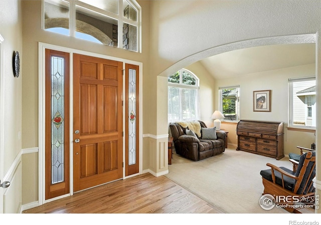 1145 Wyndemere Cir, Longmont, CO 80504 - entrance foyer with wood finished floors, arched walkways, and a towering ceiling