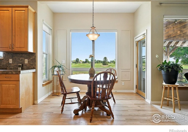 1145 Wyndemere Cir, Longmont, CO 80504 - dining area with light wood-style floors and healthy amount of natural light