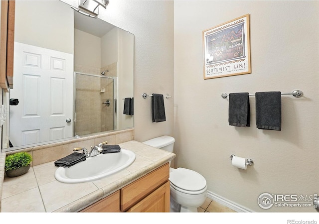 1145 Wyndemere Cir, Longmont, CO 80504 - full bathroom featuring tiled shower, vanity, and tile patterned flooring