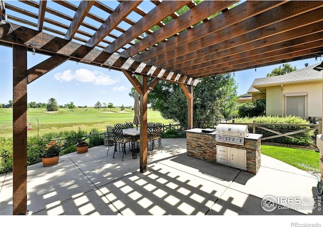 1145 Wyndemere Cir, Longmont, CO 80504 - view of patio featuring an outdoor kitchen, outdoor dining space, view of golf course, and a pergola