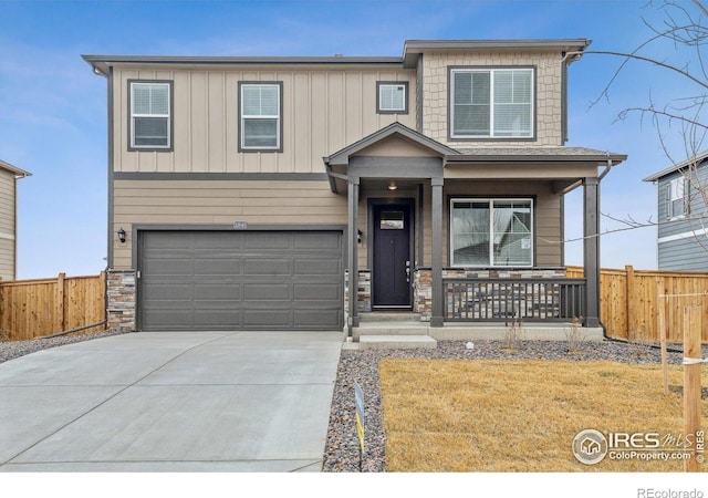 9929 Ceylon Ct, Commerce City, CO 80022 - view of front facade with a porch, an attached garage, driveway, and stone siding