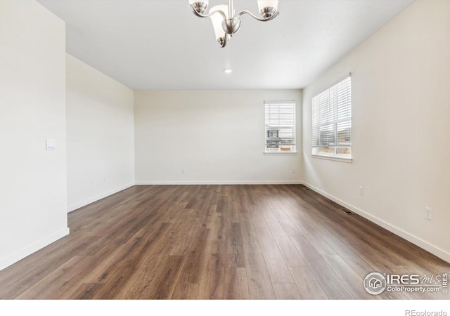 9929 Ceylon Ct, Commerce City, CO 80022 - empty room with a chandelier and wood finished floors