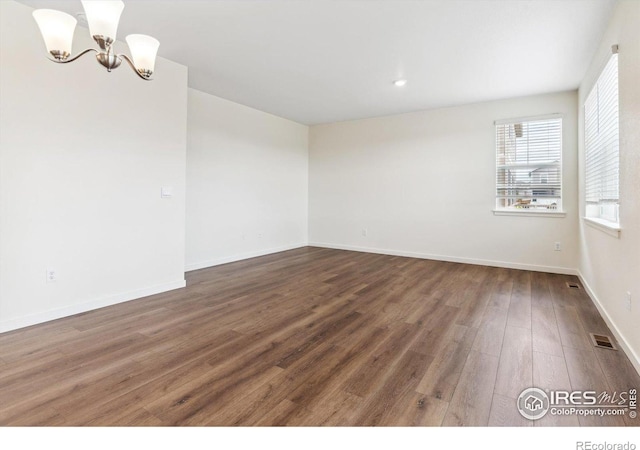 9929 Ceylon Ct, Commerce City, CO 80022 - unfurnished room featuring wood finished floors, a chandelier, and recessed lighting