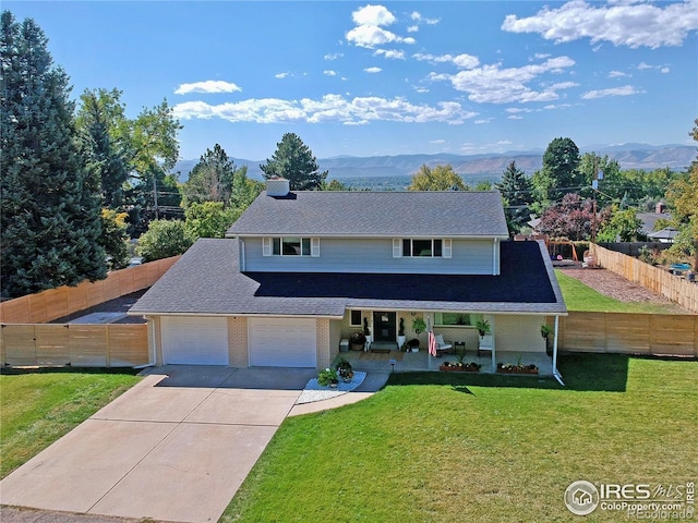 11230 W 77th Dr, Arvada, CO 80005 - traditional-style house featuring driveway, a mountain view, and covered porch