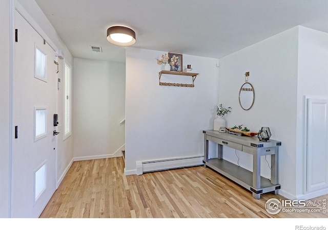 11230 W 77th Dr, Arvada, CO 80005 - entrance foyer featuring a baseboard radiator and light wood-type flooring